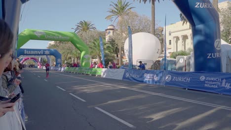 Crow-cheering-for-marathon-runner-finishing-the-last-meters-of-race---slow-motion