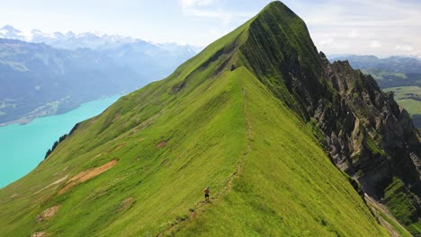 Drone-shot-following-a-running-young,-caucasian-man-on-top-of-Hardergrat-ridge-near-Interlaken-in-Switzerland