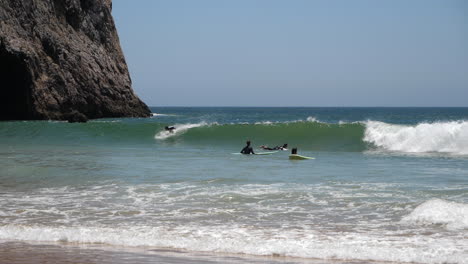 Slow-Motion-of-Surfers-and-Atlantic-Ocean-Waves-on-Beach-in-Sagres,-Algarve-Region,-Portugal