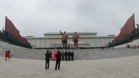 North-Korean-wedding-party-poses-for-photographers-in-front-of-Mansudae-Grand-Monument