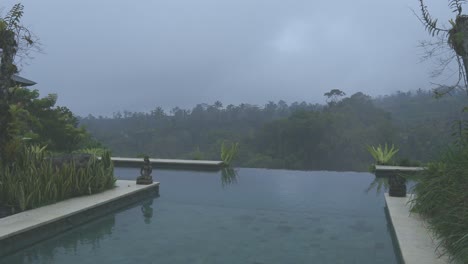 Misty-infinity-pool-in-bali,-tripod-shot-of-pool-in-the-jungle