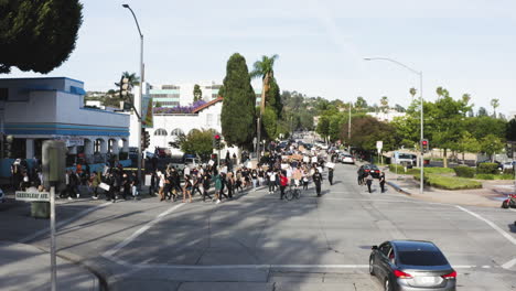 Black-Lives-Matter-protesters-on-streets,-BLM-march-rally-in-Uptown-Whittier,-aerial-view