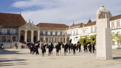 Coimbra-University-students-throwing-traditional-capes-in-the-air,-Portugal