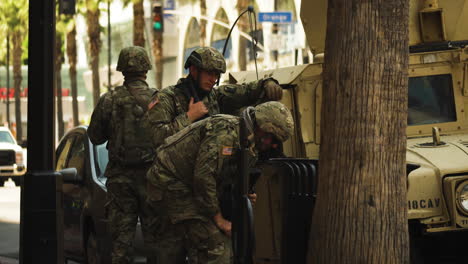 Military-officers-patrolling-Los-Angeles-streets,-Black-Lives-Matter-protest-rally