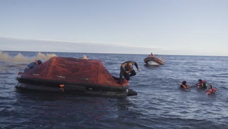 A-Seaman-With-Life-Vest-Jumps-To-The-Water-From-Inflatable-Boat-As-Part-Of-Their-Nautical-Training-In-Patagonian-Sea---Slowmo
