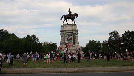 Crowd-surrounds-statue-of-famous-civil-war-general-in-Richmond,-Virginia-to-protest-racial-discrimination-and-inequality-following-death-of-unarmed-black-man-during-arrest-by-police