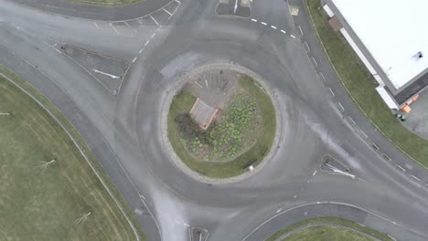 Aerial-view-above-empty-quarantine-corona-virus-outbreak-shopping-retail-car-park-roundabout-markings-descending