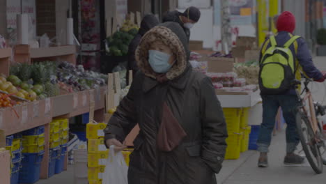 Eine-Person-Trägt-Beim-Einkaufen-Auf-Einem-Obstmarkt-Im-Freien-Eine-Chirurgische-Maske