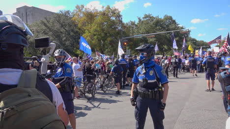 Media-covers-police-officers-and-protestors-during-gathering-after-Biden-defeats-Trump-in-2020-US-Presidential-Election-in-downtown-Austin,-TX