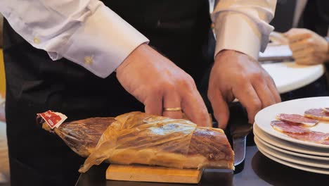 Spanish-man-slices-Lomo-sausage-onto-a-chopping-board-before-plating