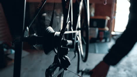 Bicycle-mechanic-changing-gears-on-a-road-bike,-tuning-up-a-Raleigh-bicycle