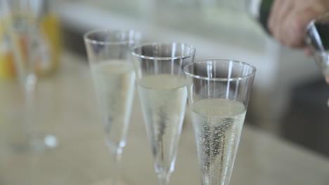 Pouring-glasses-of-champagne-at-wedding-reception