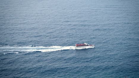 Tour-Boat,-Tourist-Sightseeing-Boat,-full-of-tourists-sailing-across-the-Cinque-Terre-sea,-Italy-coast