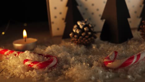 Candy-canes-in-Christmas-decorations-in-warm-candle-scene-panning-shot