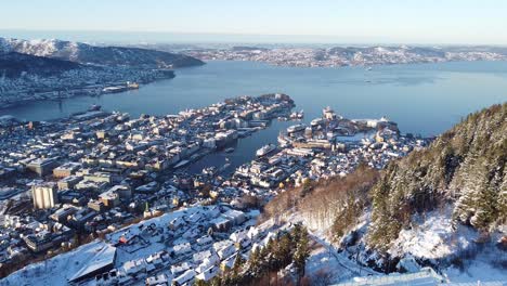 Aerial-backwards-through-mount-Floyen-with-Bergen-city-view-as-Background
