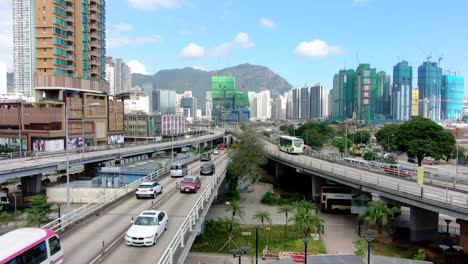 Hong-Kong-downtown-Kowloon-urban-area,-Low-angle-aerial-view-with-traffic-and-city-skyscrapers