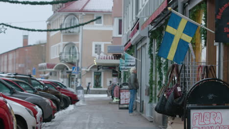 The-Swedish-flag-on-a-shopping-street-in-Sweden-during-the-covid-19-pandemic
