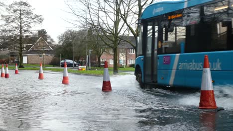 Storm-Christoph-car-bus-police-car-driving-rainy-flooding-village-road-splashing-street-cones