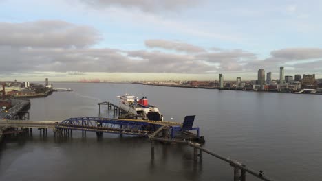 Stena-Line-logistics-ship-terminal-aerial-view-Birkenhead-Liverpool-harbour-city-landscape-pull-away-orbit-right
