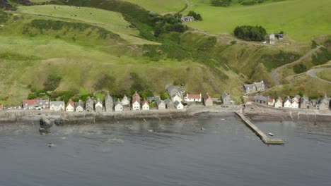 Aerial-view-of-the-Crovie-village-on-the-Aberdeenshire-coastline-on-an-overcast-summer-evening