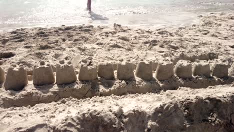 Sandcastle-at-beach.-Waves---walking-legs