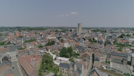 AERIAL:-A-city-with-its-church-dominating-the-view-on-a-beautiful,-summer-day