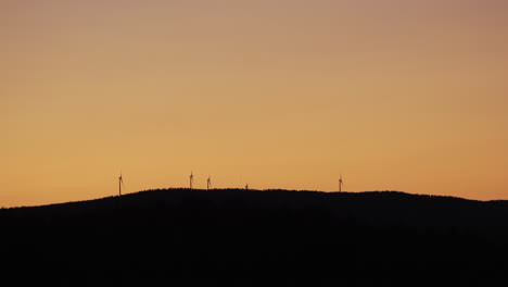 Wind-power-generator-turbines,-at-a-sunny-evening-dusk,-in-Hoga-Kusten,-Vasternorrland,-Sweden