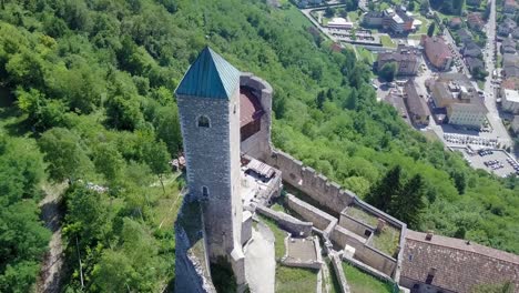 Aerial-view-of-Castel-Telvana-in-Borgo-Valsugana,-Trentino,-Italy-with-drone-flying-around-the-tower-in-a-very-clear-day