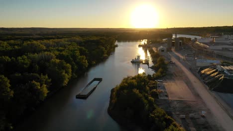 aerial-sunset-above-river-near-industrial-park