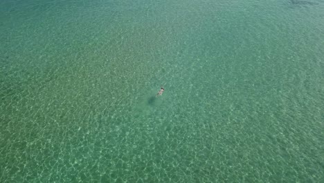 Female-tourist-swims-in-the-clear-green-waters-of-the-Aegean-Sea