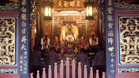 Religious-women-praying-together-at-Dalongdong-Baoan-Temple-in-Taipei,-Taiwan