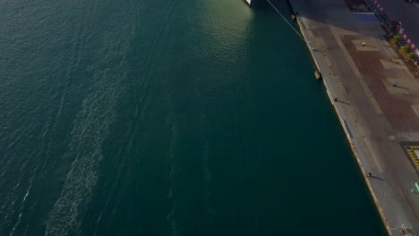 Aerial-view-of-water-trails-from-jet-skies-and-camera-tilting-up-to-establish-a-shot-of-the-cruise-ship-4K