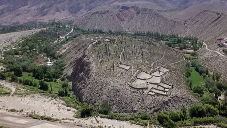 Aerial-view-over-the-Pucará-de-Tilcara,-a-pre-Inca-fortification-outside-the-small-town-of-Tilcara-in-Argentina