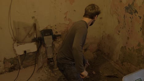 Filling-wheelbarrow-with-old-broken-concrete-house-renovation