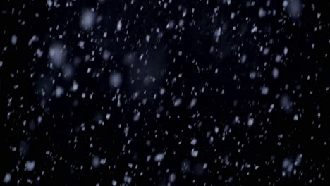 Falling-snow-in-the-night,-snowflakes-with-black-background-in-winter