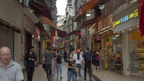 Time-lapse-of-busy-Macau-shops-street-with-numerous-crowds-of-tourists-passing-back-and-forth,-Macau-SAR,-China