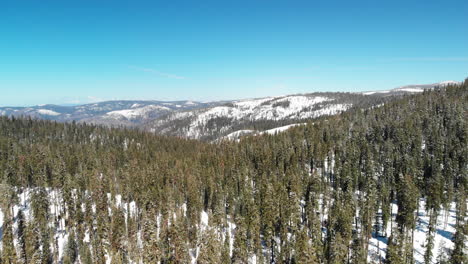 Aerial-shot-over-vast-Sierra-Nevada-wilderness-in-the-winter-snow-pack