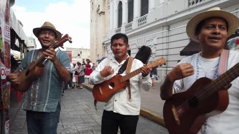 Woman-passes-some-money-and-the-mariachi-musicians-continue-to-play-and-sing