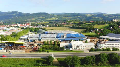 Industrial-zone-Slovenska-Bistrica-from-the-air,-small-enterprises-and-local-business-with-manufacturing-building-and-waste-management-plant-in-front