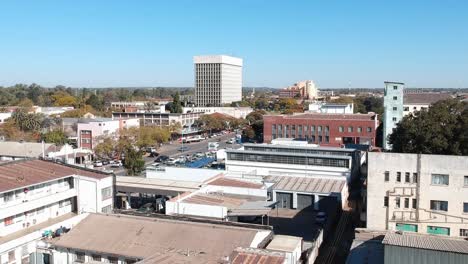 A-push-up-drone-shot-of-Bulawayo's-Tower-Block-under-sunny-conditions