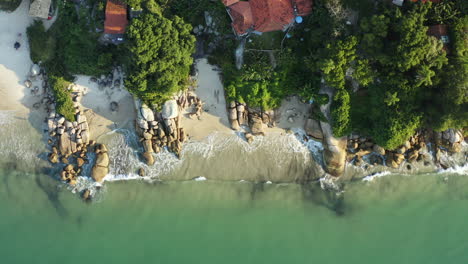 Drone-aerial-top-down-view-beach-with-turquoise-colored-water-sunset,-Jurere-Internacional,-Florianopolis,-Santa-Catarina,-Brazil