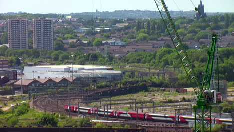 Single-LNER-InterCity-125-Train-departing-Leeds-Station-snaking-along-Bending-Track-on-a-Summer’s-Day-with-Blue-Sky---Crane-in-Foreground