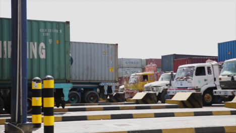 A-pan-view-of-the-entrance-of-a-port-where-heavy-long-vehicles-are-waiting-for-their-turns-to-verification's