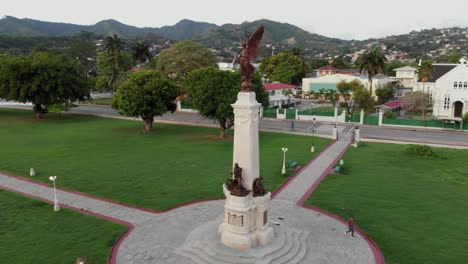 Epic-aerial-of-a-memorial-cenotaph-statue-with-a-performing-arts-center-in-the-background