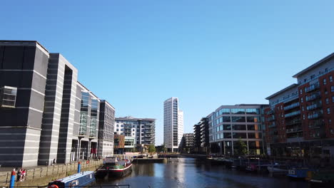 Shot-of-Leeds-Dock-Mixed-Development-in-Yorkshire,-UK-on-a-Sunny-Summer’s-Day-Fading-Out-Upwards-to-Blue-Sky-in-Slow-Motion