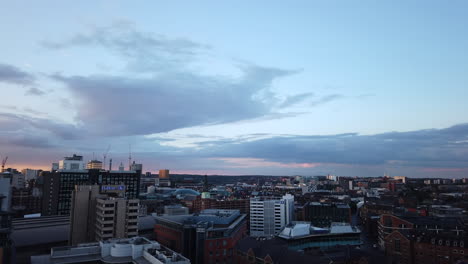 Zeitraffer-Des-Sonnenuntergangs-über-Dem-Stadtzentrum-Von-Leeds-Mit-Langen-Schatten-Und-Rosa-violetten-Wolken,-Die-In-Die-Dunkelheit-übergehen
