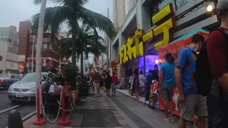 Point-of-view-of-a-pedestrian-weaving-through-tourists-on-the-sidewalk