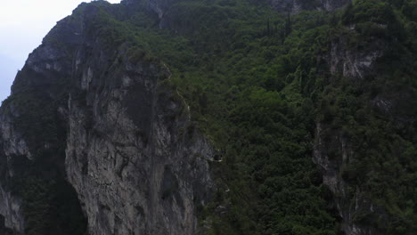 Aerial-shot-of-a-narrow-mountain-trail-above-Lago-Di-Garda-Italy