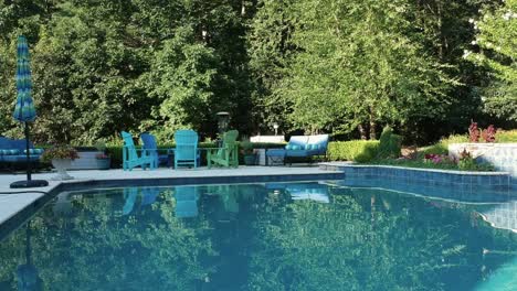 Aerial-flyover-of-a-residential-porch-with-a-turquoise-pool,-forward