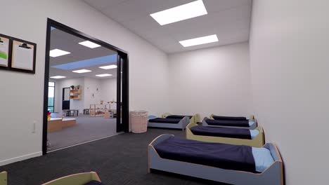 Jib-up-shot-of-a-resting-area-with-beds-for-kids-in-a-Playcentre,-New-Zealand
